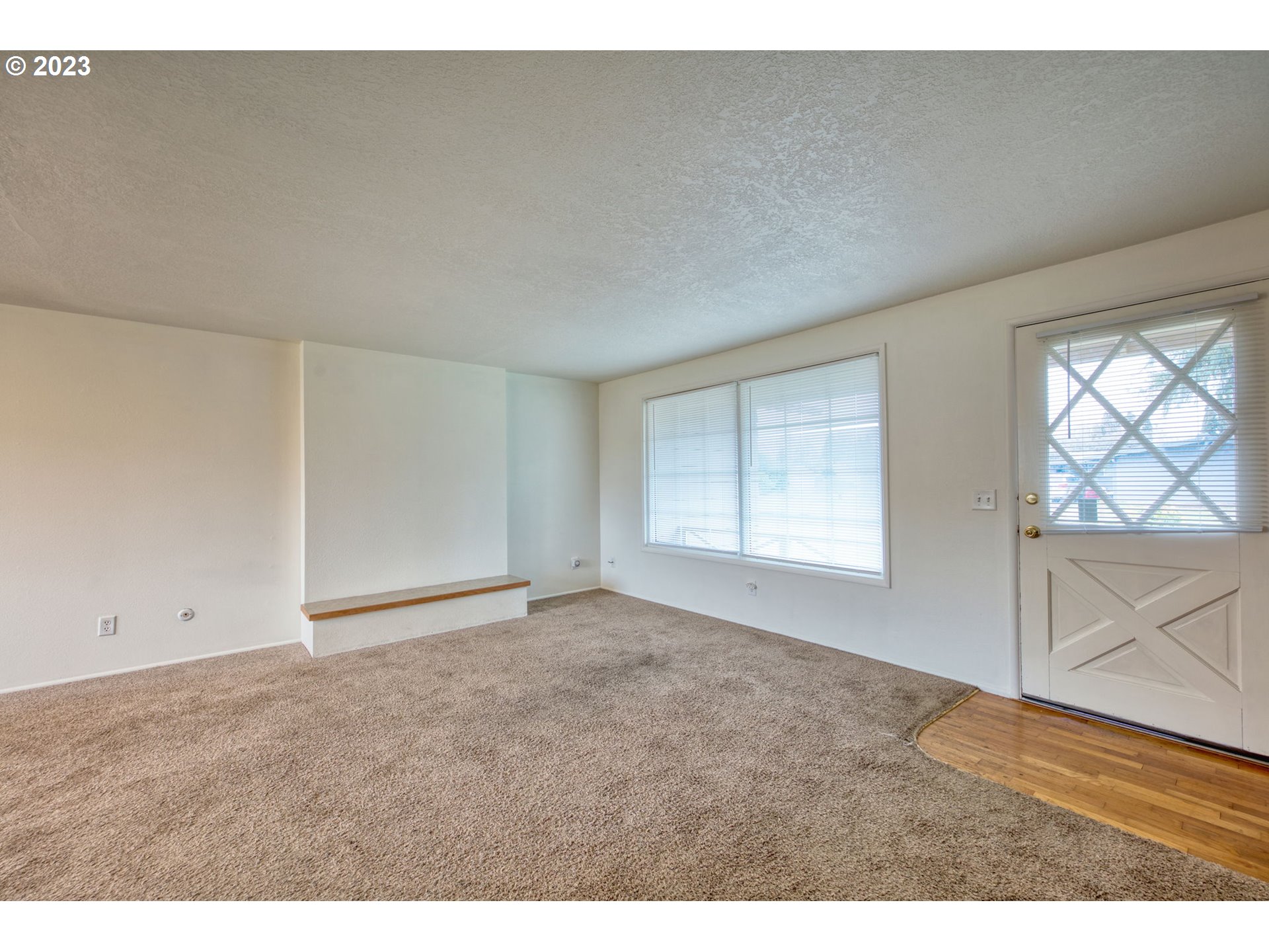 823 South 38th Street Springfield, OR 97478 - Photo 5 of 26 a view of an empty room with wooden floor and windows
