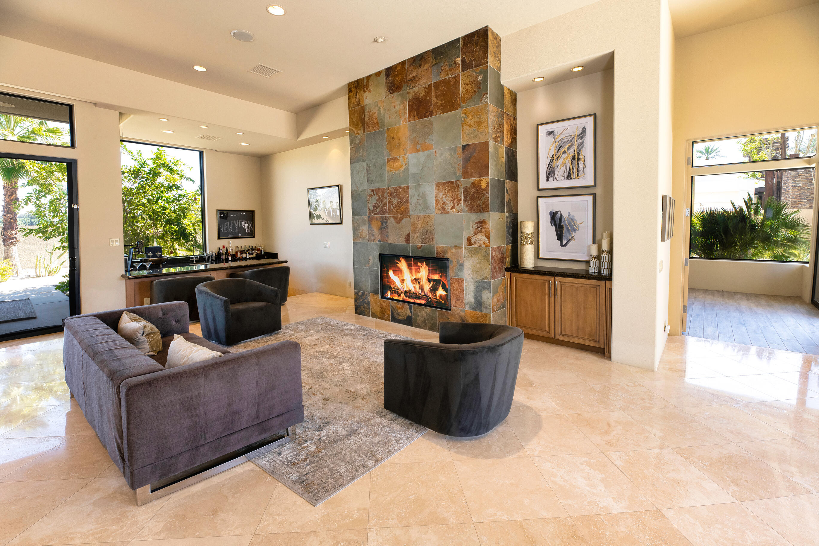 29 Sun Ridge Circle Rancho Mirage, CA 92270 - Photo 15 of 57 a living room with furniture a flat screen tv and a fireplace