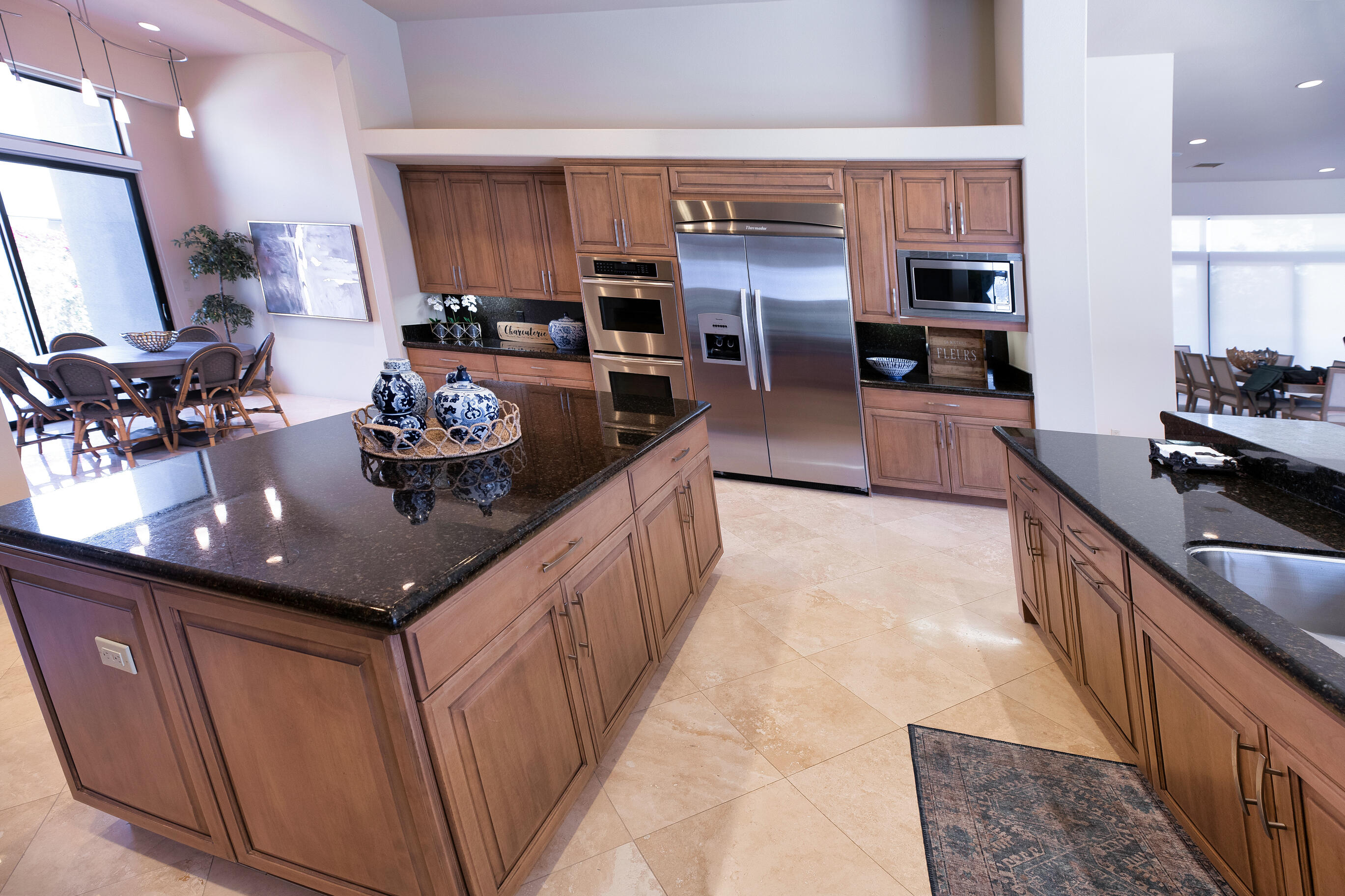 29 Sun Ridge Circle Rancho Mirage, CA 92270 - Photo 20 of 57 a kitchen with stainless steel appliances granite countertop a sink stove and refrigerator