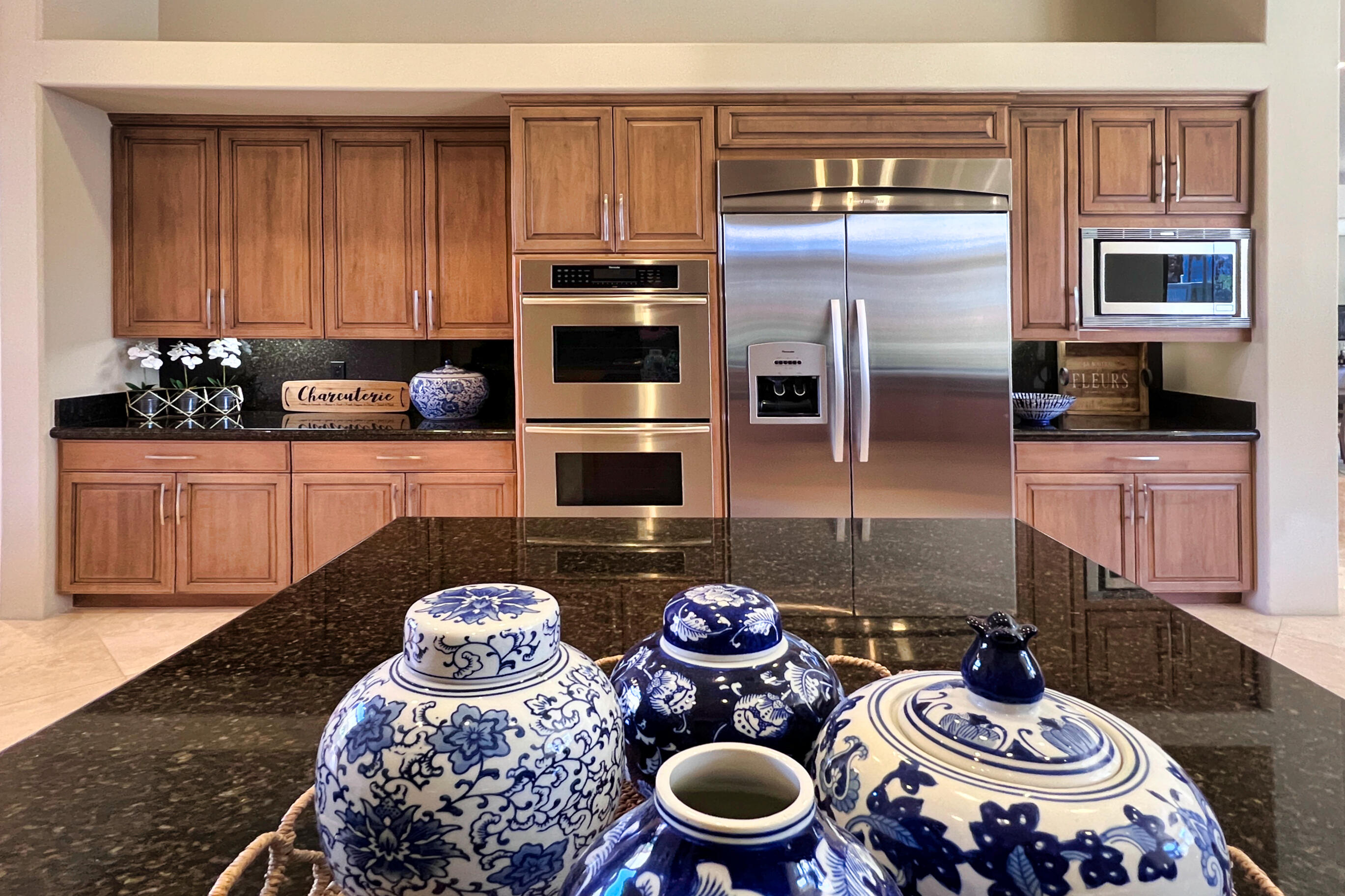 29 Sun Ridge Circle Rancho Mirage, CA 92270 - Photo 24 of 57 a kitchen with stainless steel appliances a dining table and chairs