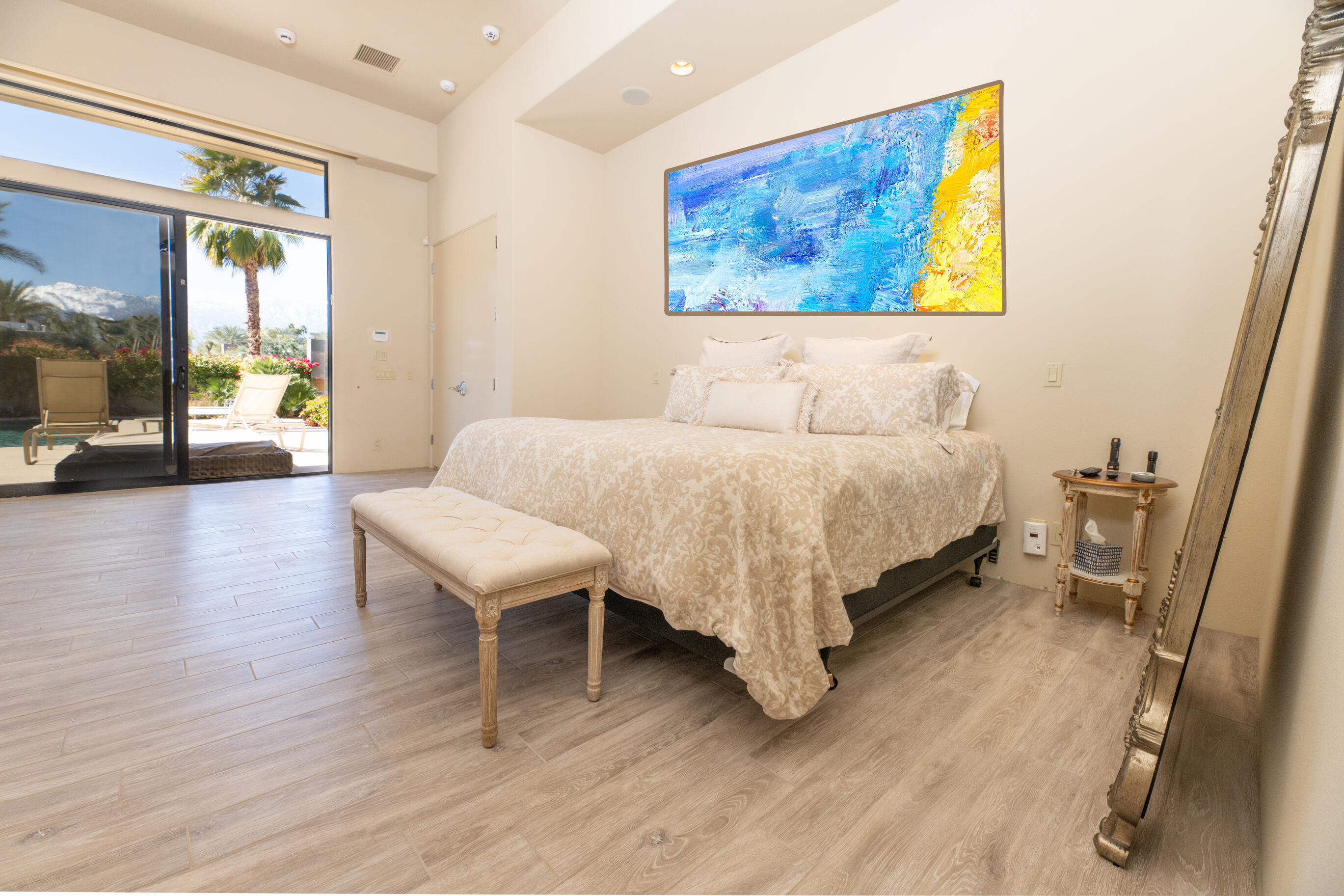 29 Sun Ridge Circle Rancho Mirage, CA 92270 - Photo 27 of 57 a bedroom with a bed and a painting on the wall