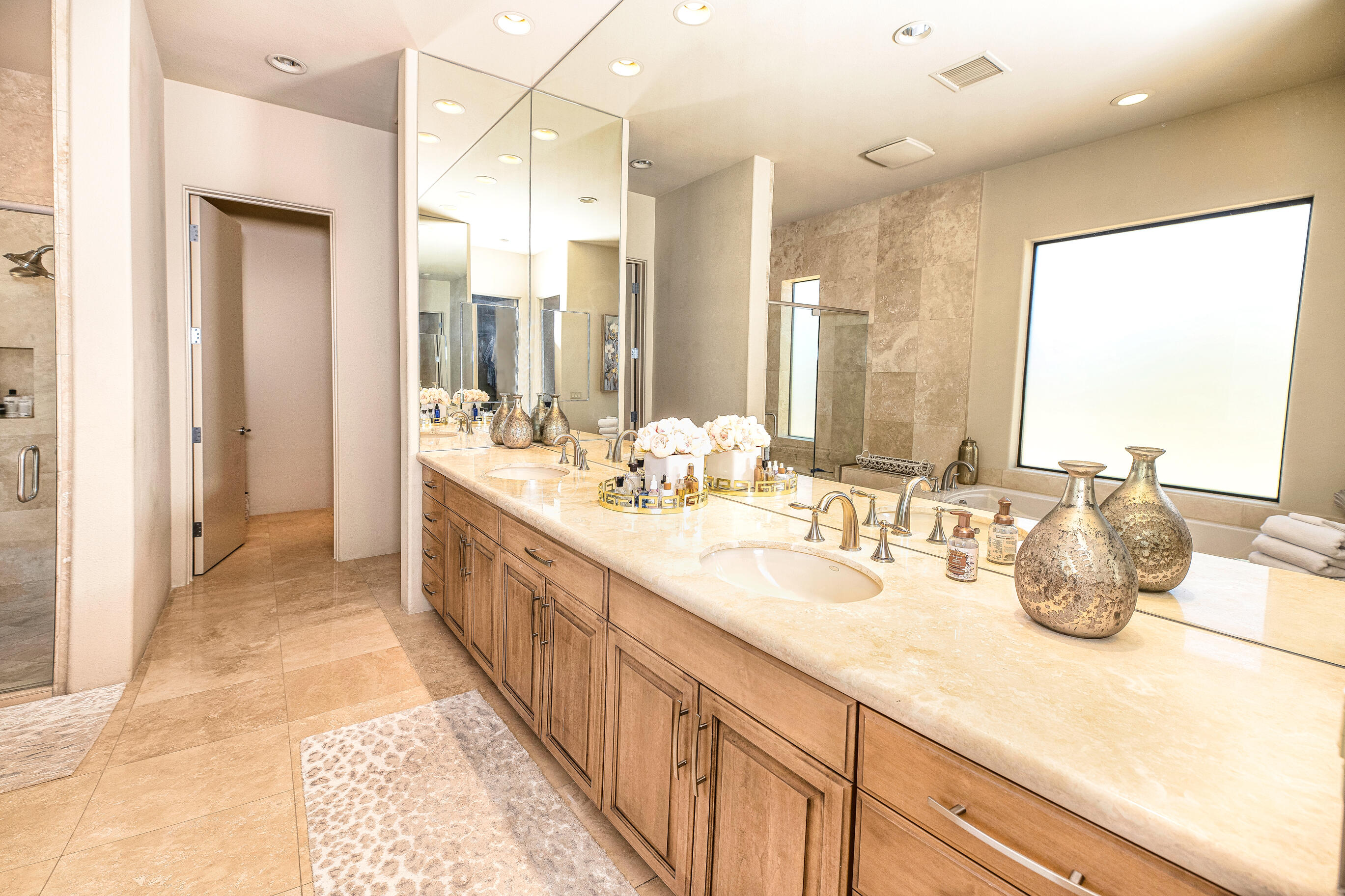 29 Sun Ridge Circle Rancho Mirage, CA 92270 - Photo 30 of 57 a spacious bathroom with a double vanity sink and a large mirror