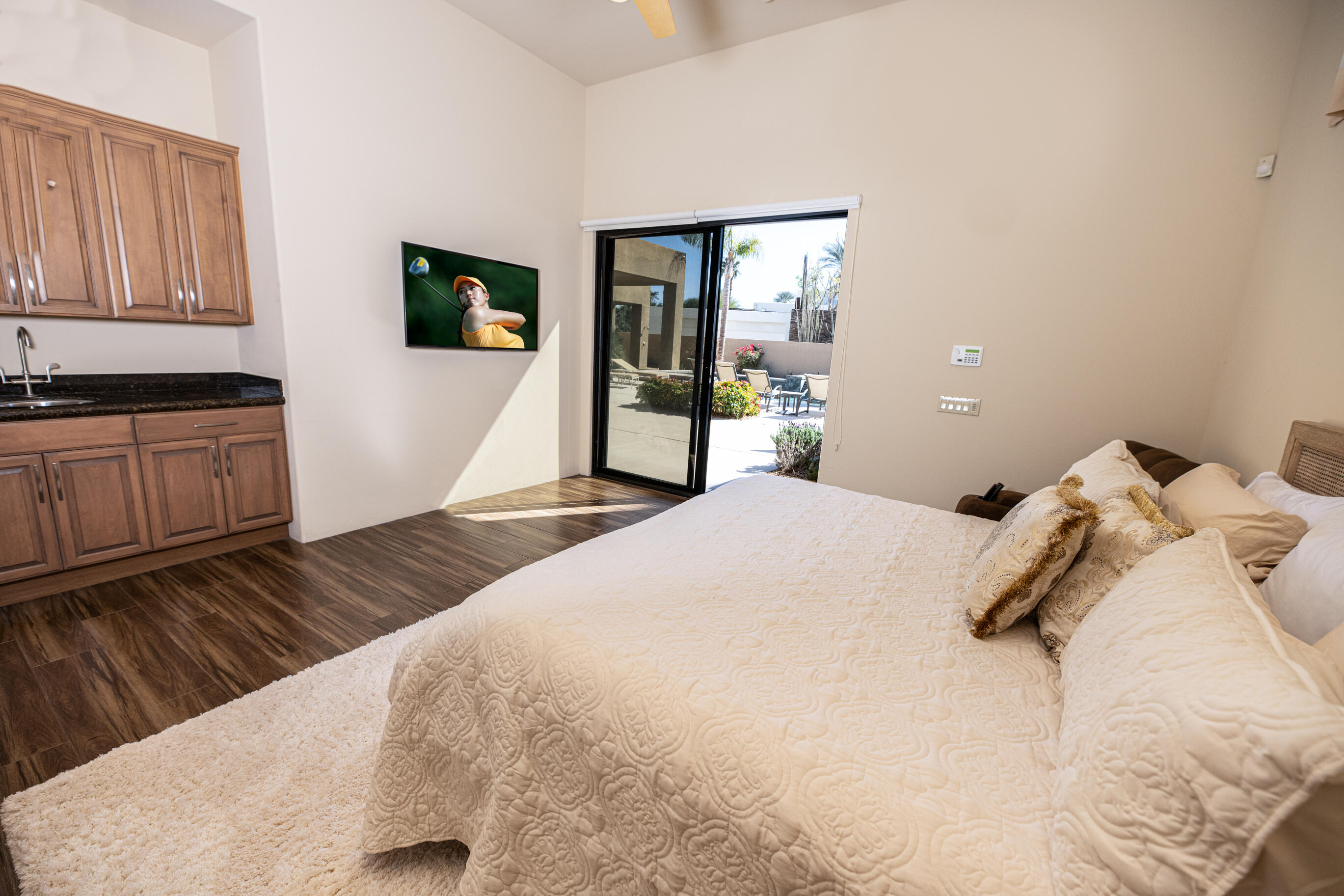 29 Sun Ridge Circle Rancho Mirage, CA 92270 - Photo 37 of 57 a bedroom with a bed and wooden floor