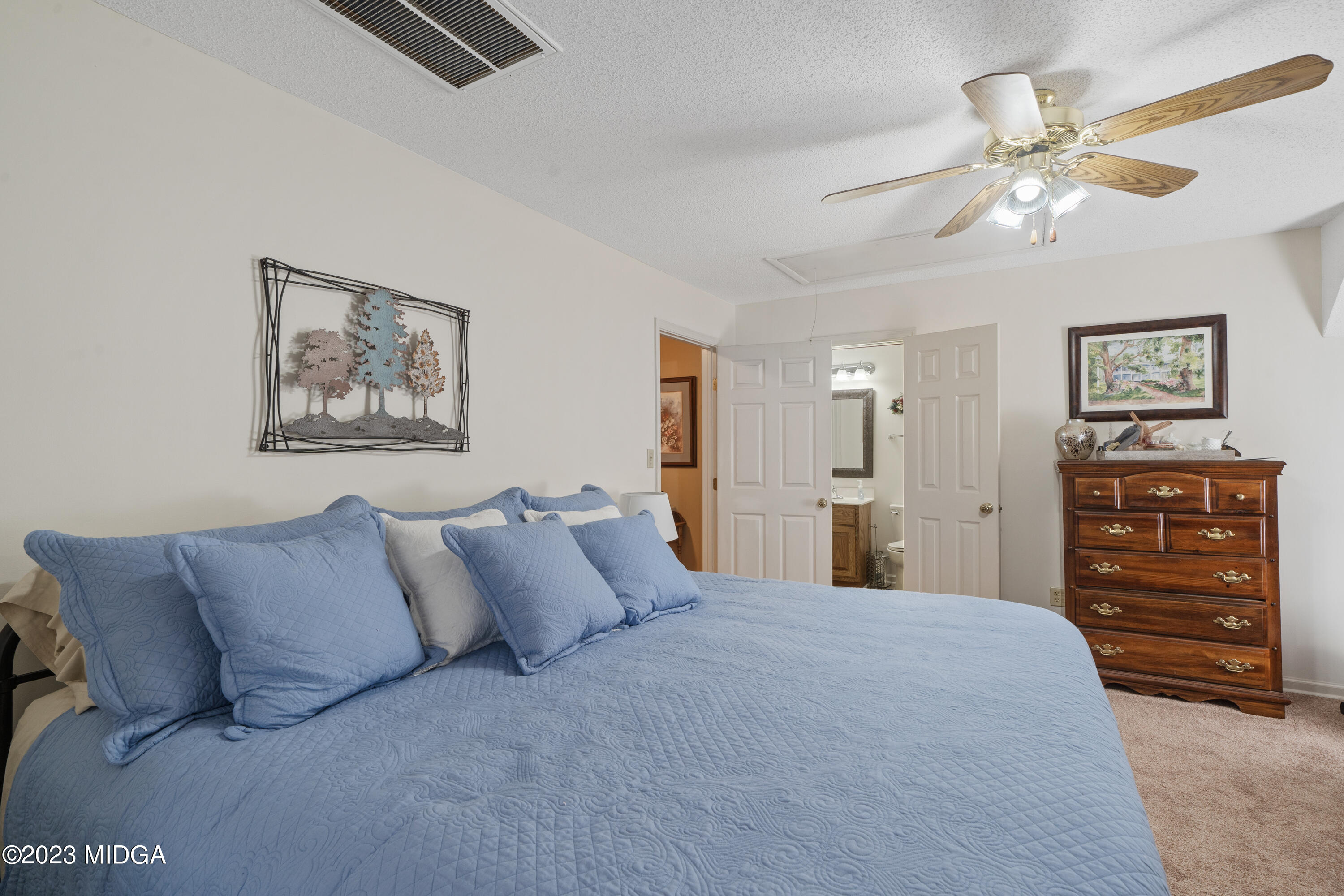729 Sanders Road Macon, GA 31210 - Photo 18 of 29 a bedroom with a bed and a chandelier