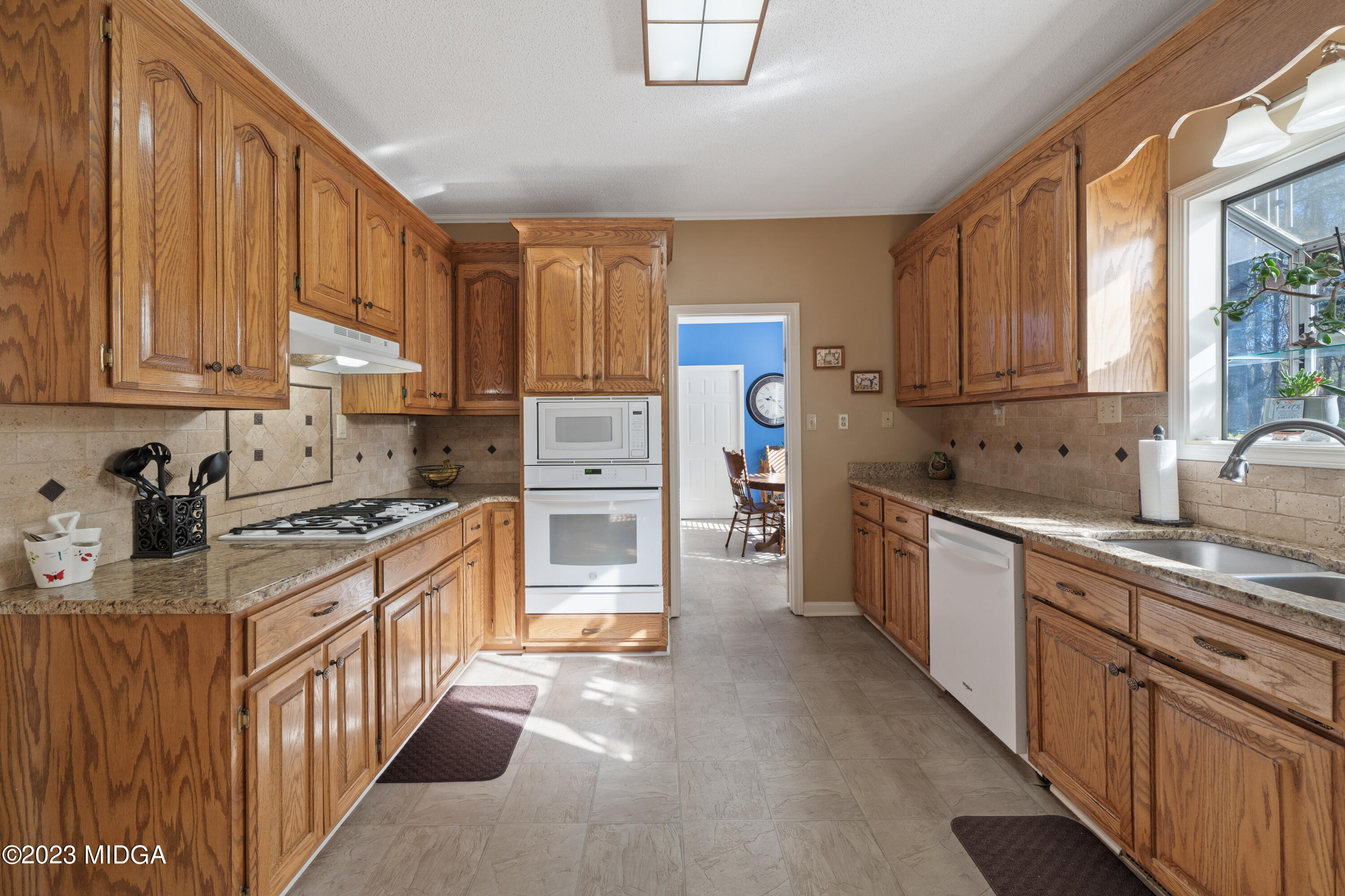 729 Sanders Road Macon, GA 31210 - Photo 6 of 29 a kitchen with stainless steel appliances granite countertop a stove top oven a sink dishwasher and a refrigerator with cabinets