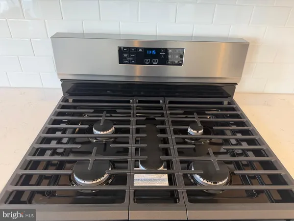 a close view of stove top oven and cabinets