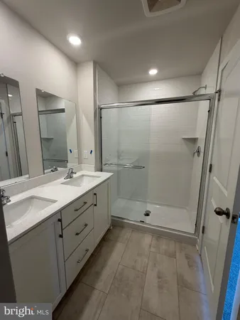 a white toilet sitting next to a white cabinet