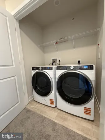 a white toilet sitting next to a white sink and vanity