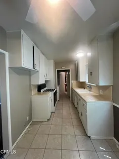 a kitchen with a sink a counter top space and cabinets
