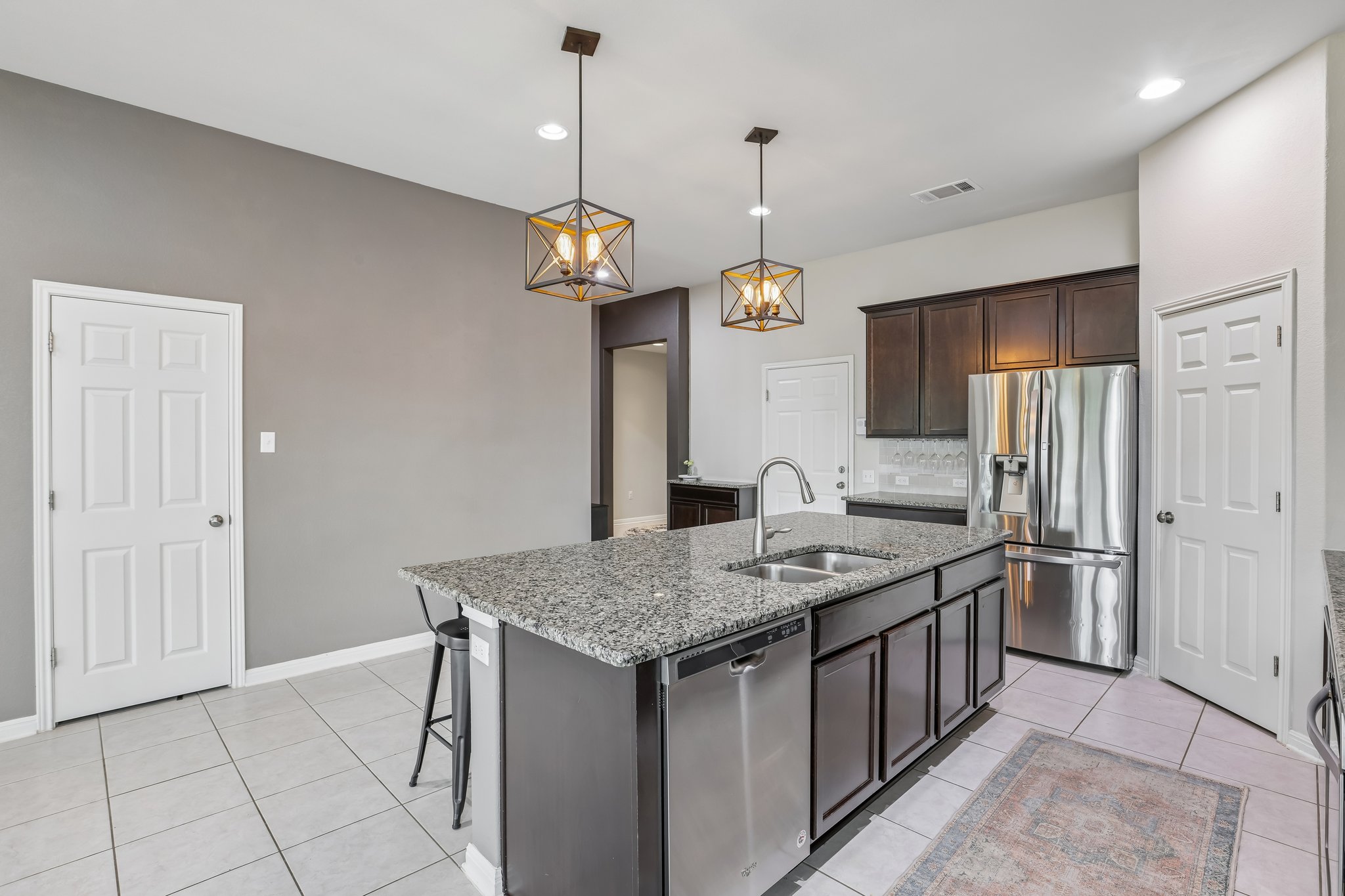 6801 Banff Cove Austin, TX 78754 - Photo 6 of 37 An inviting kitchen with granite countertops featuring a large island with a sink