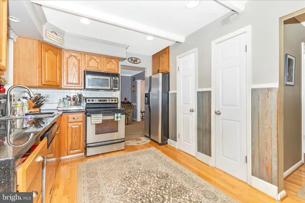 a kitchen with stainless steel appliances granite countertop a refrigerator and a stove top oven