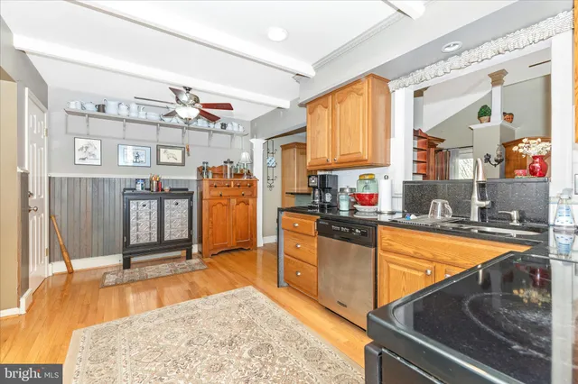 a kitchen with stainless steel appliances granite countertop a refrigerator stove top oven and sink