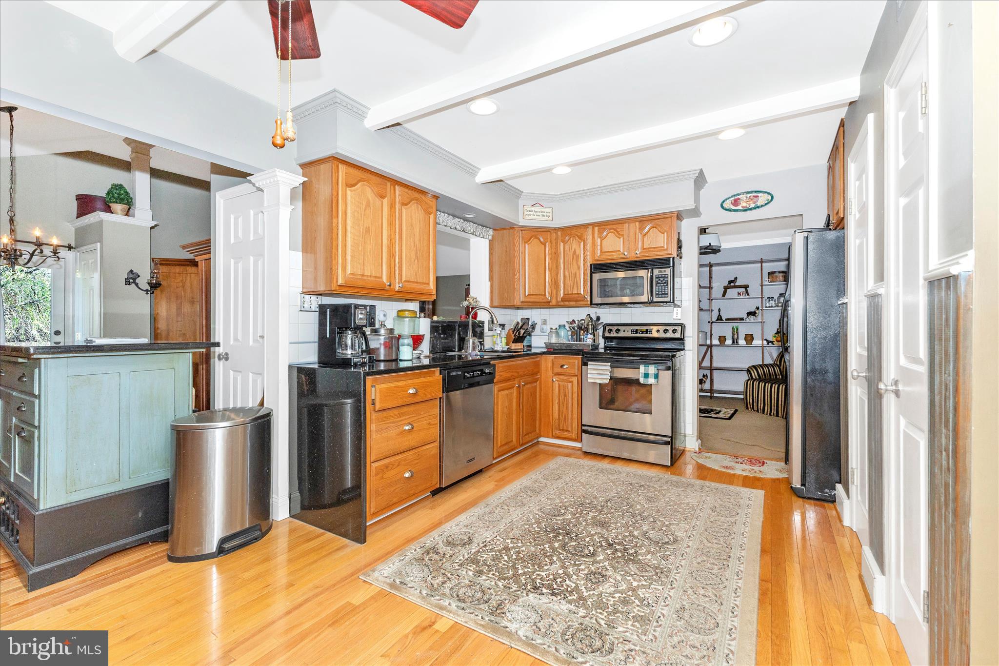 1111 Cummings Avenue Baltimore, MD 21228 - Photo 15 of 48 a kitchen with stainless steel appliances granite countertop a refrigerator stove top oven and sink