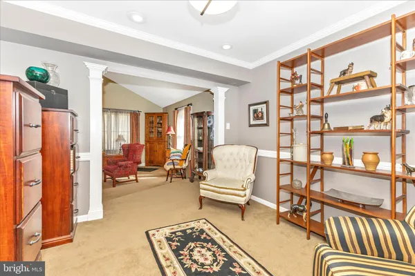 a bedroom with furniture and a book shelf