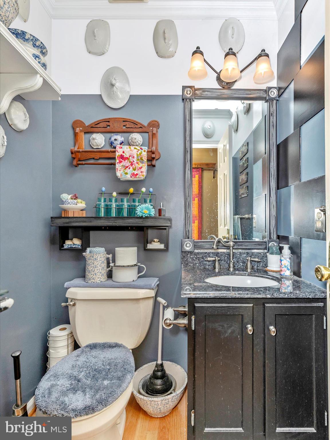 1111 Cummings Avenue Baltimore, MD 21228 - Photo 22 of 48 a bathroom with a toilet a sink and a mirror