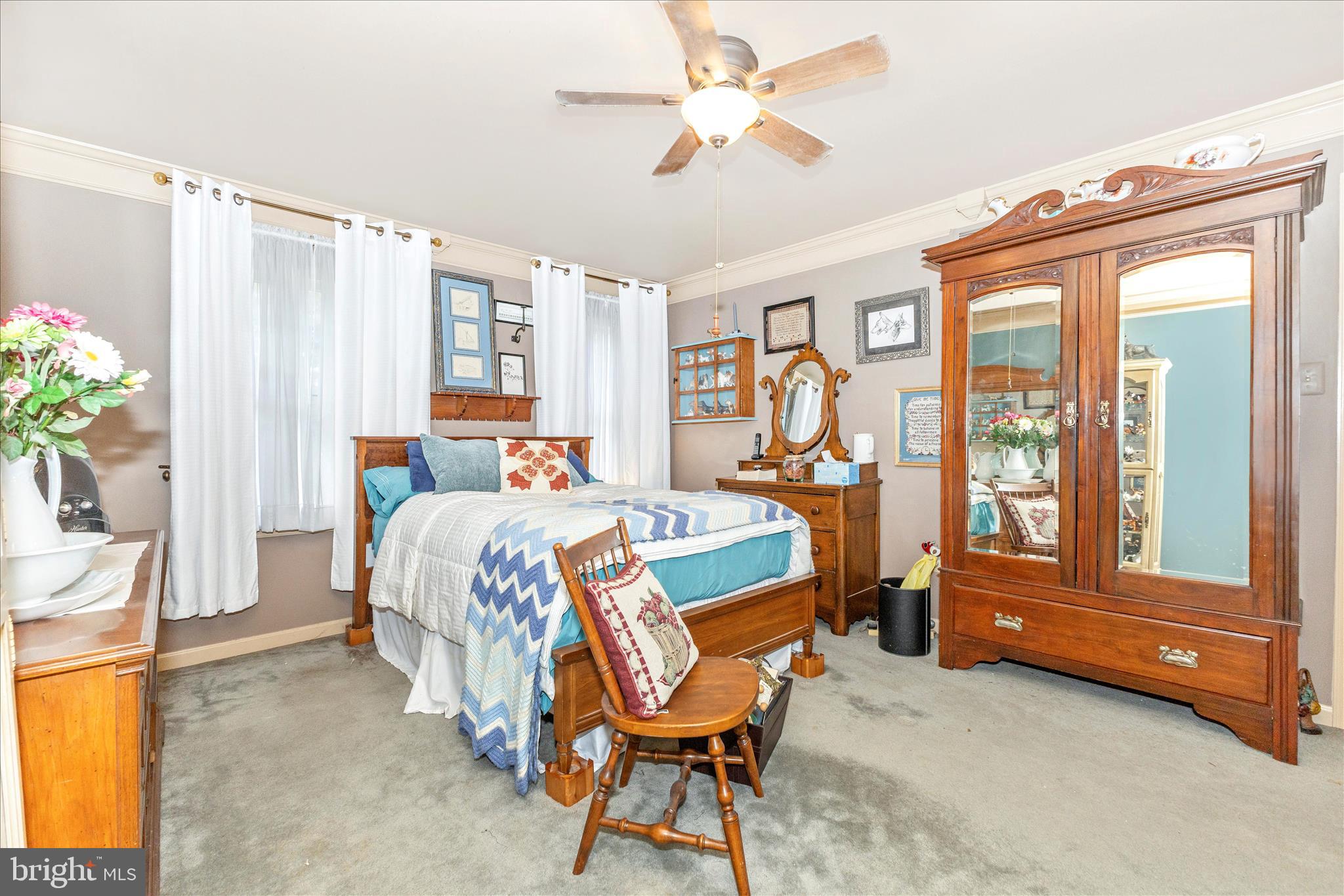 1111 Cummings Avenue Baltimore, MD 21228 - Photo 24 of 48 a bedroom with a bed and a chandelier