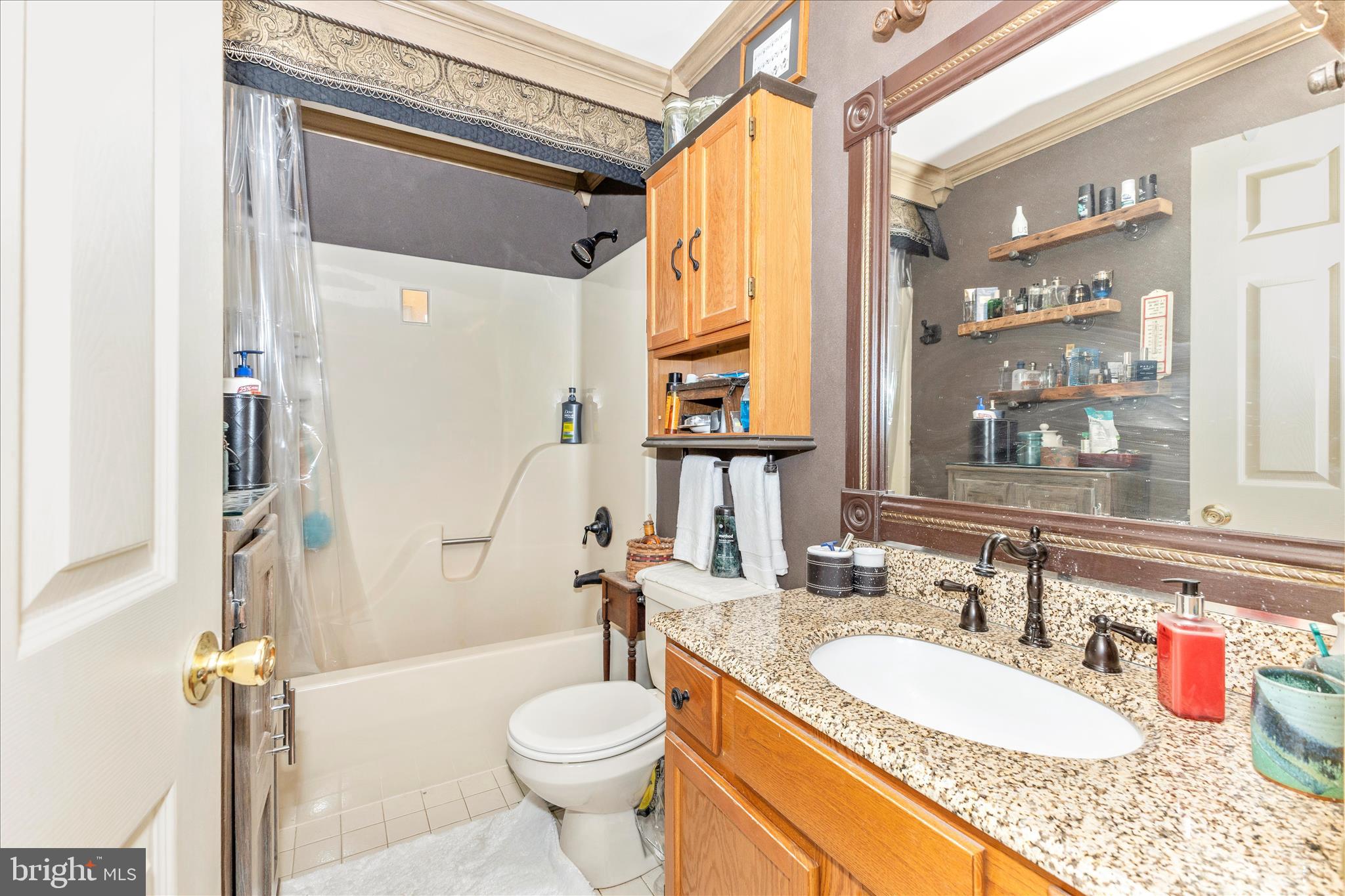 1111 Cummings Avenue Baltimore, MD 21228 - Photo 25 of 48 a bathroom with a granite countertop sink and a mirror