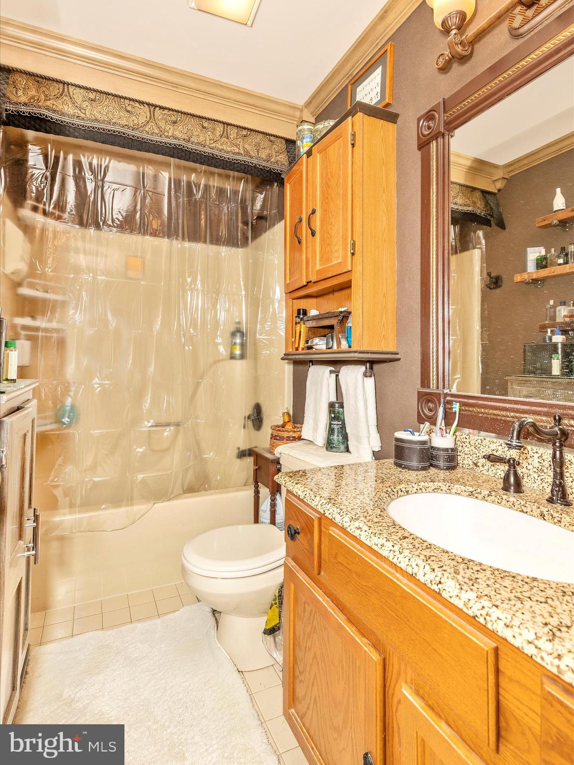 1111 Cummings Avenue Baltimore, MD 21228 - Photo 26 of 48 a bathroom with a granite countertop bathtub sink vanity mirror and toilet