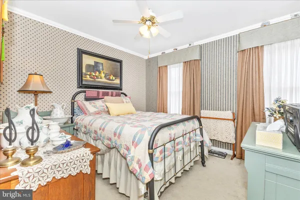 a bedroom with a bed and a mirror