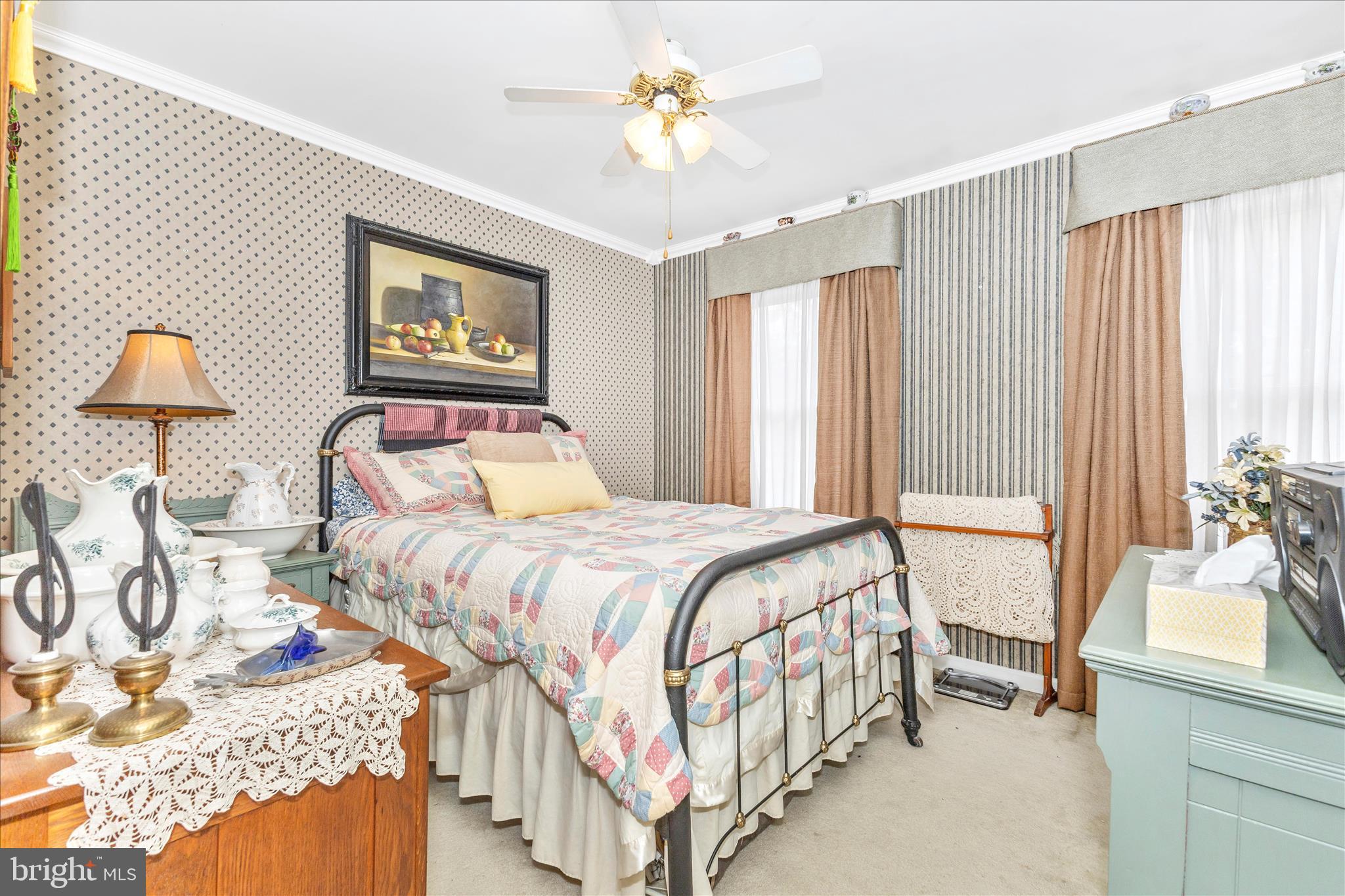 1111 Cummings Avenue Baltimore, MD 21228 - Photo 28 of 48 a bedroom with a bed and a chandelier