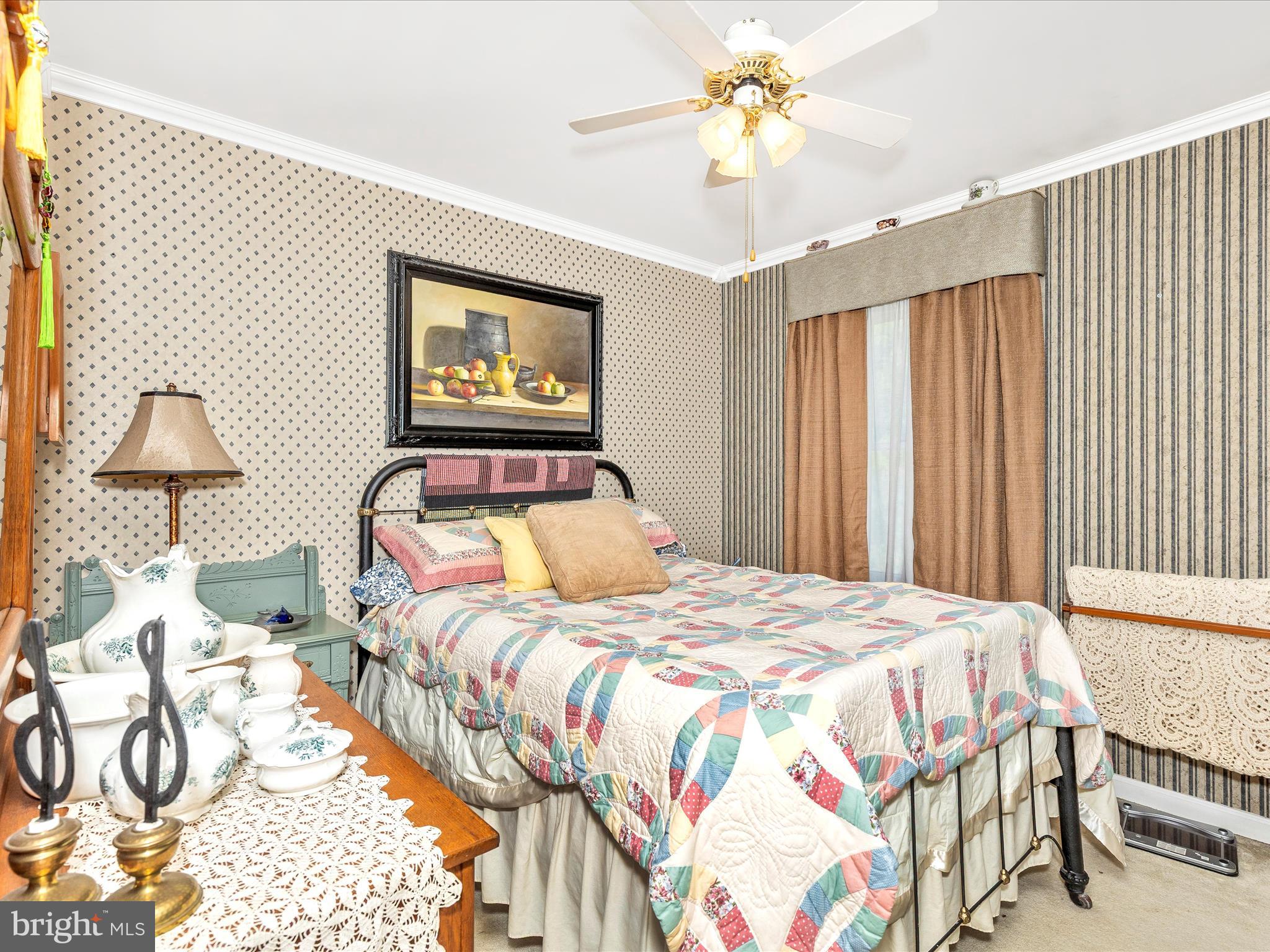 1111 Cummings Avenue Baltimore, MD 21228 - Photo 29 of 48 a bedroom with a bed and a chandelier