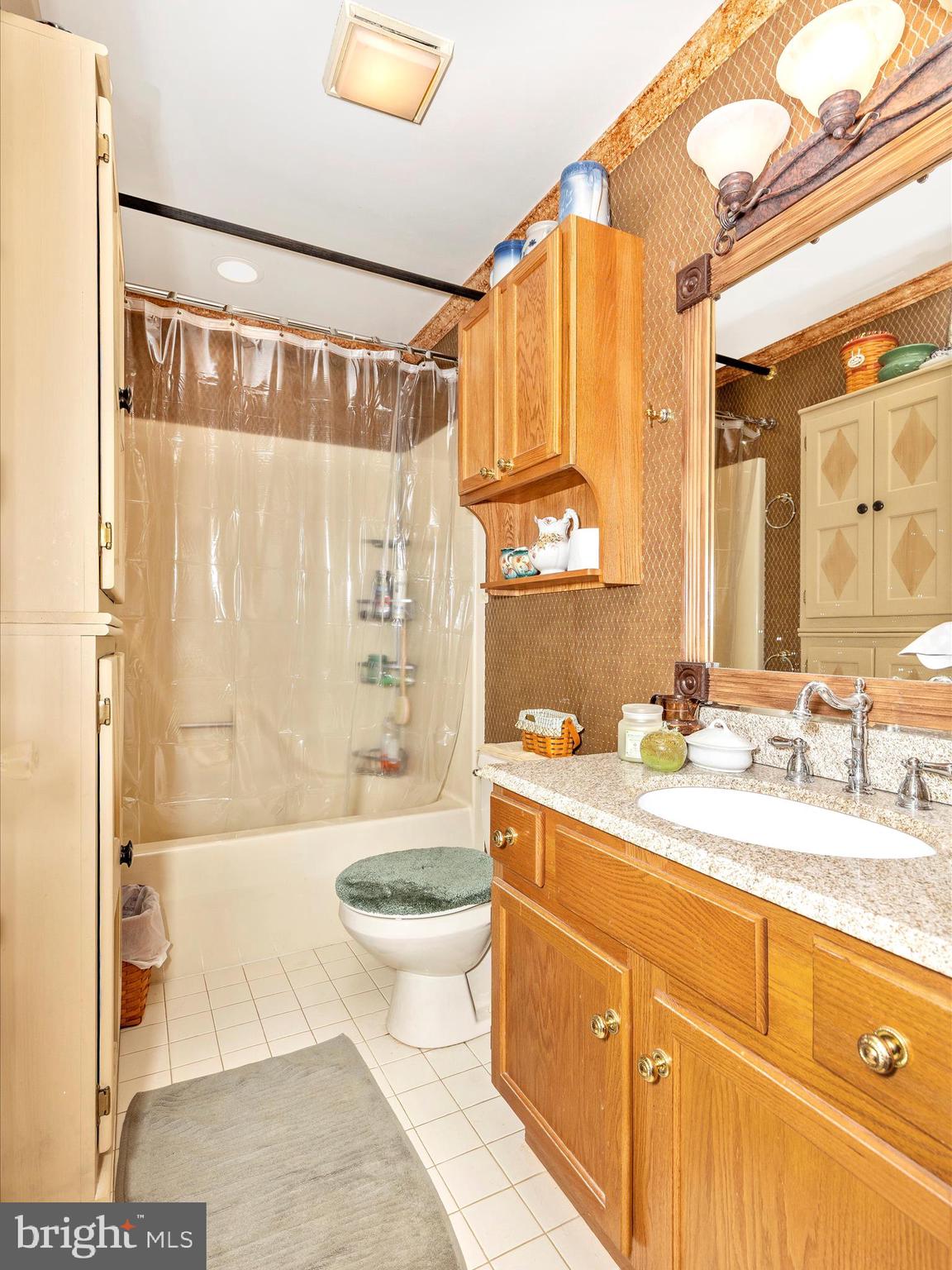 1111 Cummings Avenue Baltimore, MD 21228 - Photo 33 of 48 a bathroom with a double vanity sink toilet mirror and bathtub