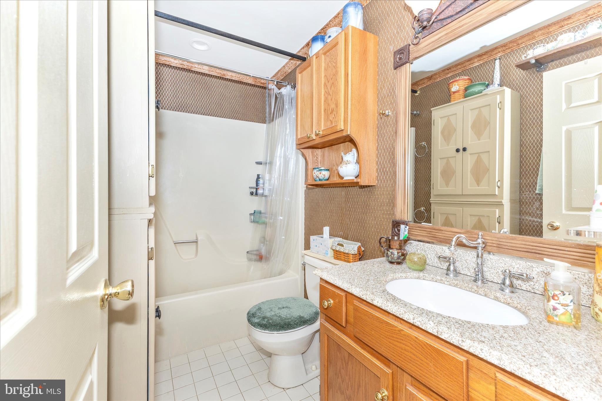 1111 Cummings Avenue Baltimore, MD 21228 - Photo 34 of 48 a bathroom with a granite countertop sink toilet and shower