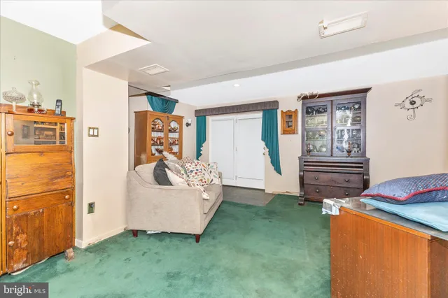 a living room with furniture cabinets and window