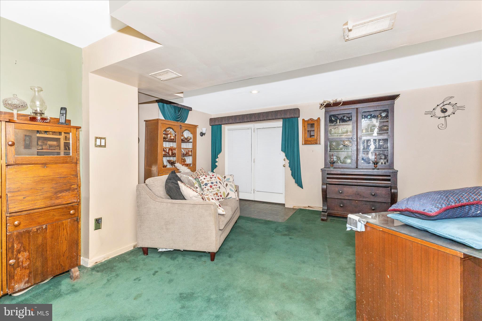1111 Cummings Avenue Baltimore, MD 21228 - Photo 35 of 48 a living room with furniture and a refrigerator