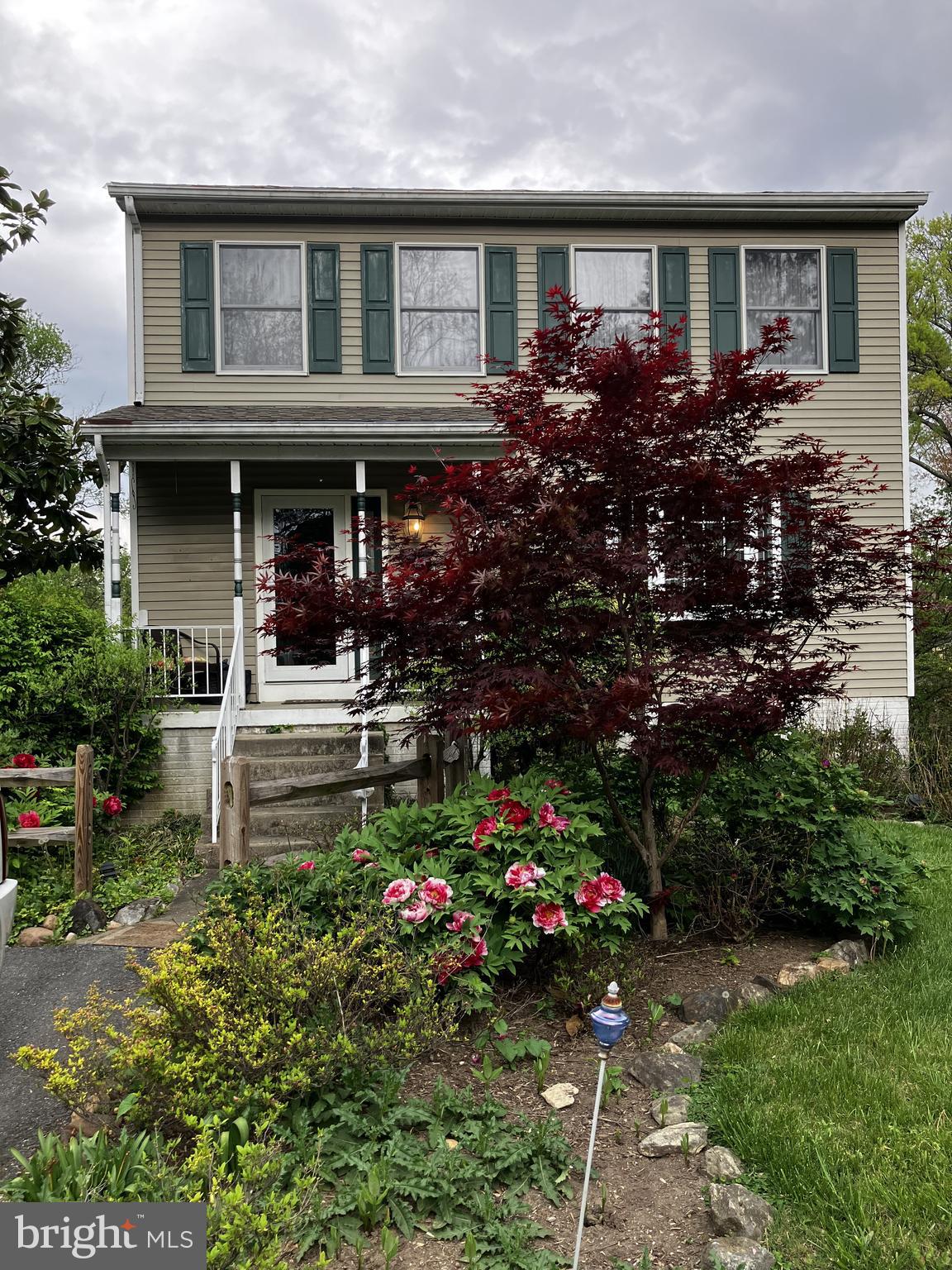 1111 Cummings Avenue Baltimore, MD 21228 - Photo 42 of 48 a front view of a house with a garden