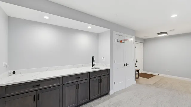 a spacious bathroom with a double vanity sink a mirror and a bathtub