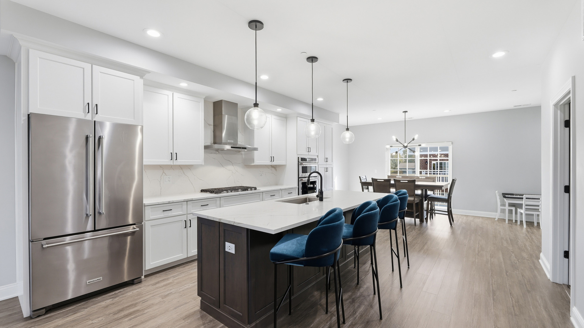 416 North Cass Avenue, Unit 6 Westmont, IL 60559 - Photo 3 of 24 a kitchen with stainless steel appliances a dining table chairs stove refrigerator and wooden floor