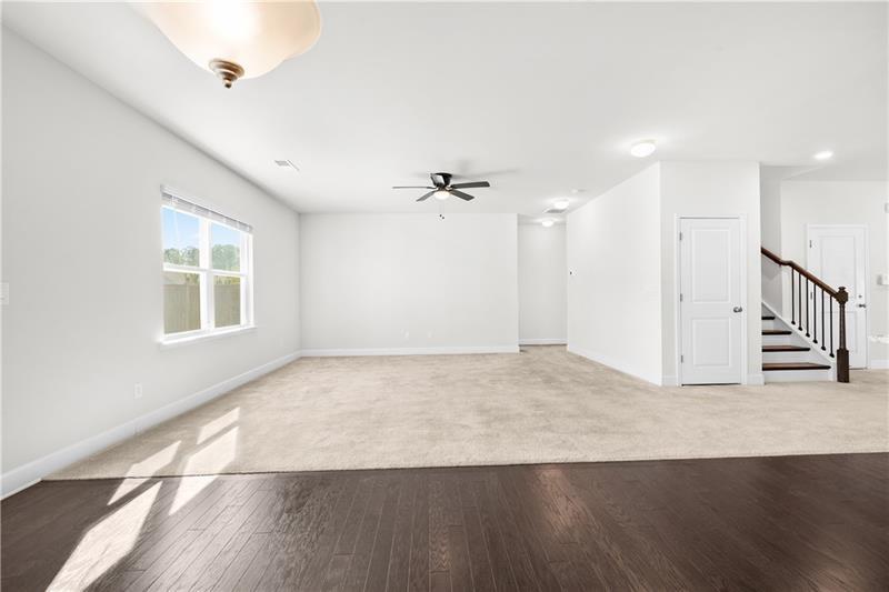 5689 Wheeler Ridge Road Auburn, GA 30011 - Photo 12 of 40 an empty room with wooden floor cabinet and windows