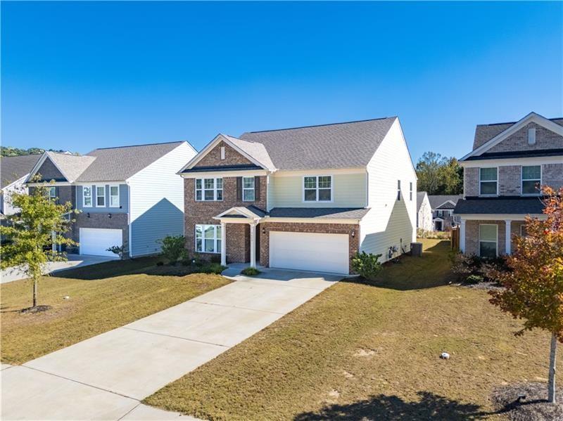 5689 Wheeler Ridge Road Auburn, GA 30011 - Photo 2 of 40 a front view of a house with a yard