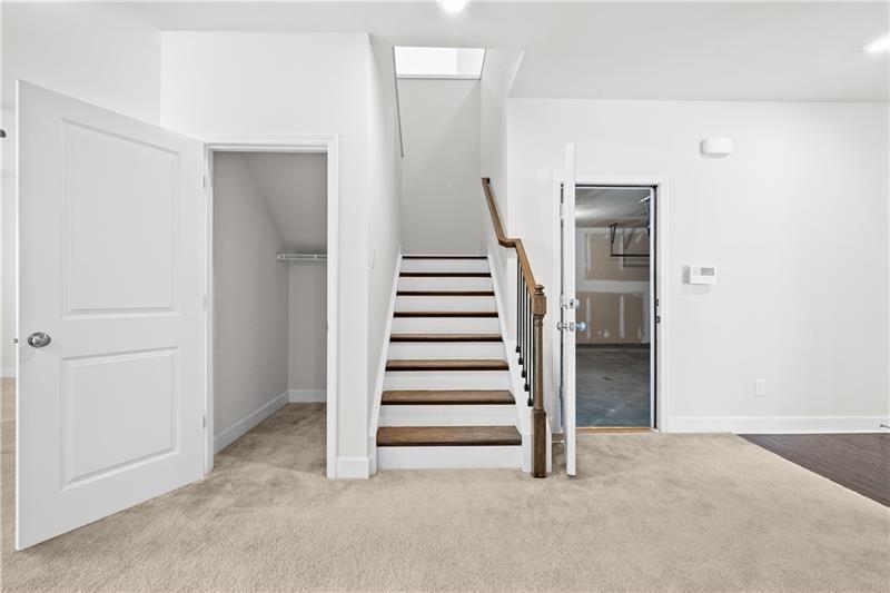 5689 Wheeler Ridge Road Auburn, GA 30011 - Photo 22 of 40 an empty room with a white cabinet and stairs
