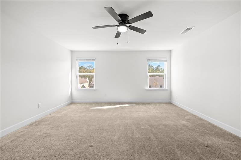 5689 Wheeler Ridge Road Auburn, GA 30011 - Photo 27 of 40 an empty room with fan and windows