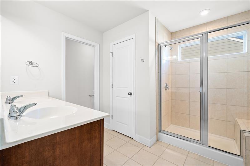 5689 Wheeler Ridge Road Auburn, GA 30011 - Photo 31 of 40 a bathroom with a sink and a mirror