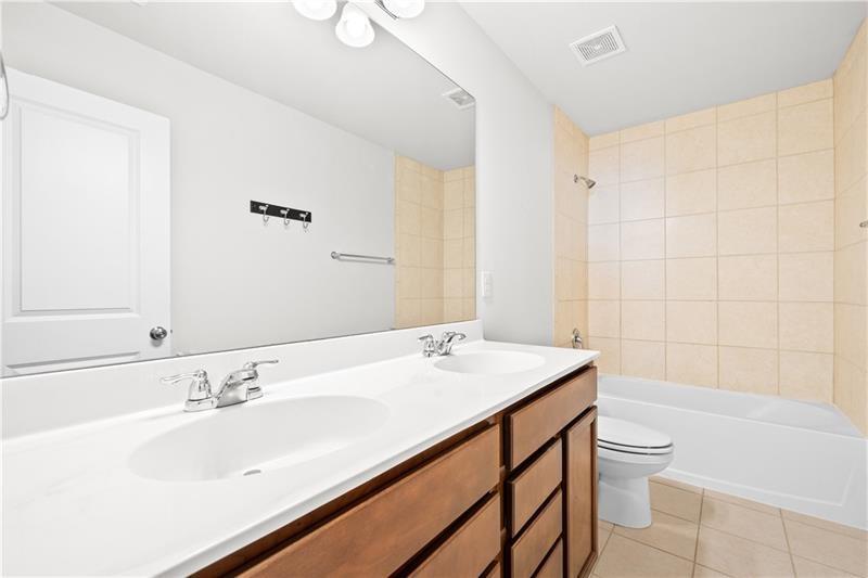 5689 Wheeler Ridge Road Auburn, GA 30011 - Photo 40 of 40 a bathroom with a sink a toilet and shower