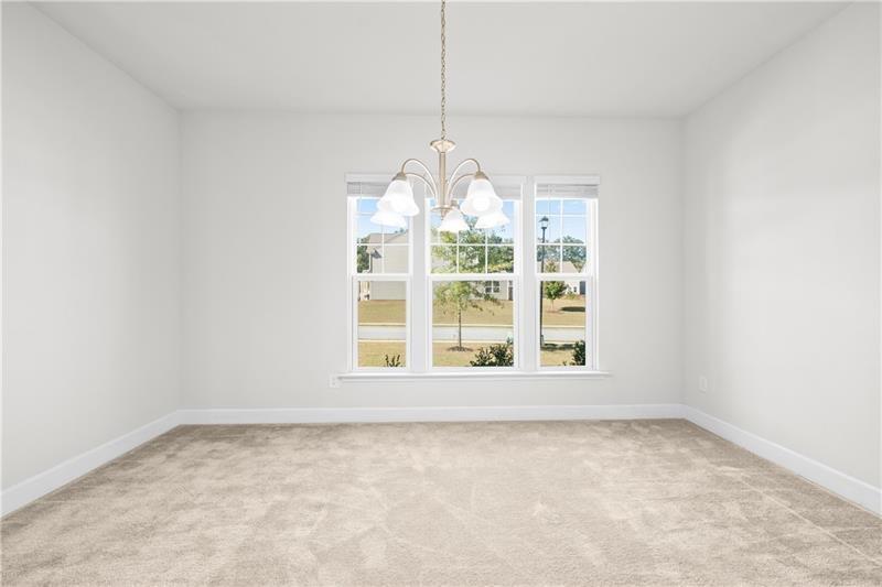 5689 Wheeler Ridge Road Auburn, GA 30011 - Photo 7 of 40 an empty room with windows and outdoor view