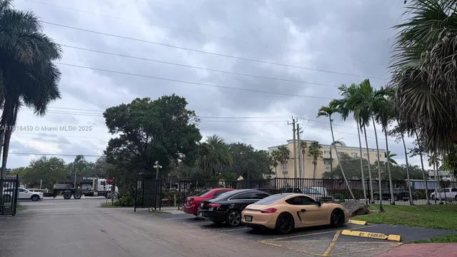 a view of cars parked on the side of a street