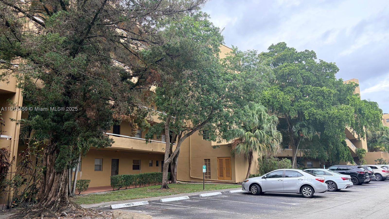 4111 Stirling Road, Unit 102 Fort Lauderdale, FL 33314 - Photo 4 of 13 a car parked in front of a white house