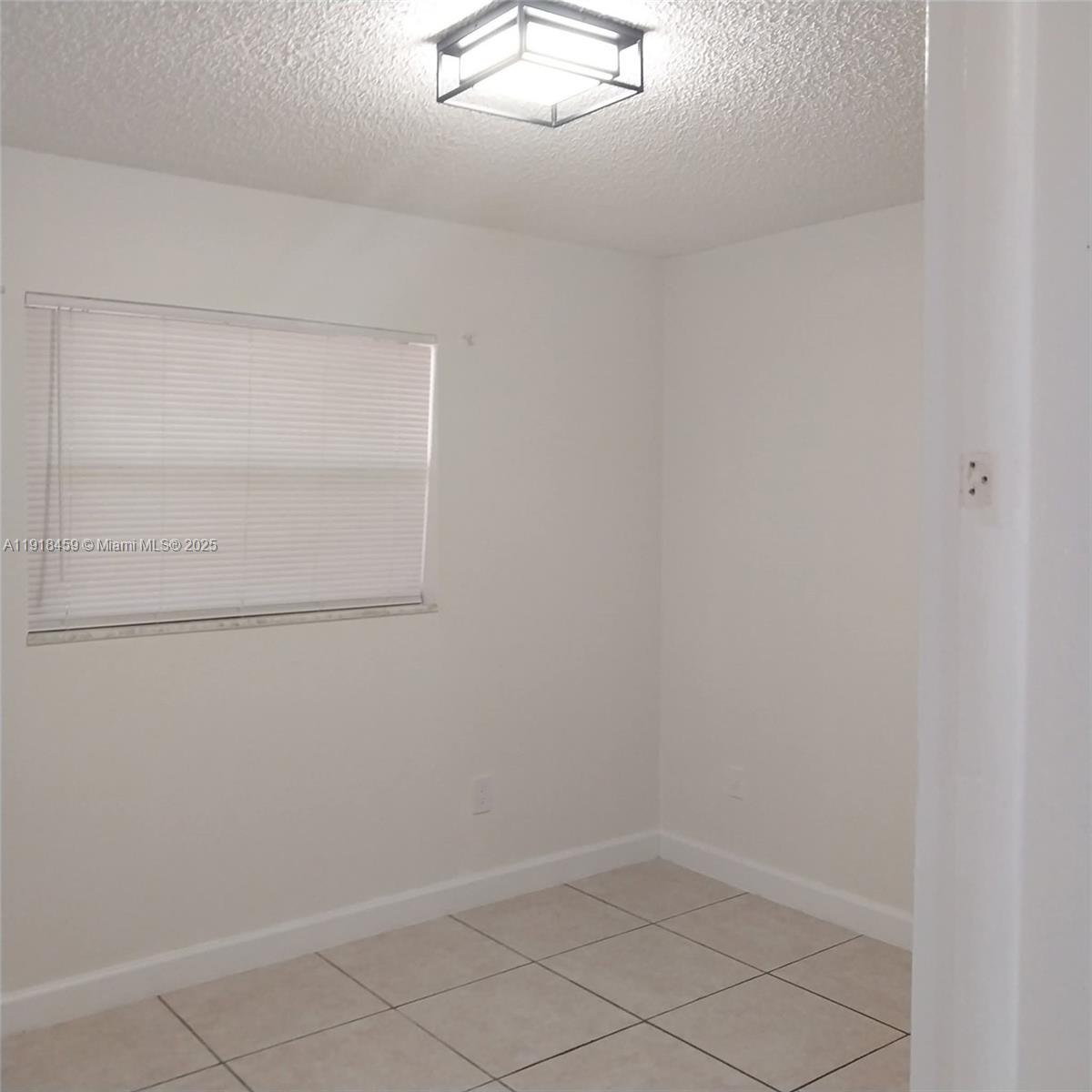 4111 Stirling Road, Unit 102 Fort Lauderdale, FL 33314 - Photo 9 of 13 an empty room
