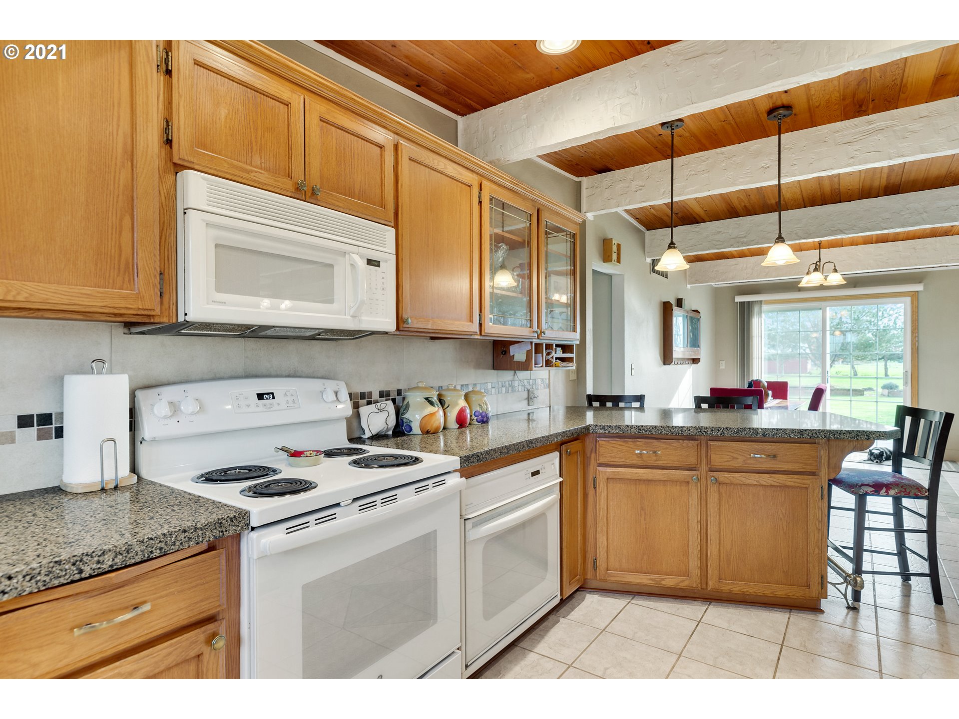 7320 South Mark Road Canby, OR 97013 - Photo 10 of 28 a kitchen with stainless steel appliances granite countertop a sink stove and cabinets