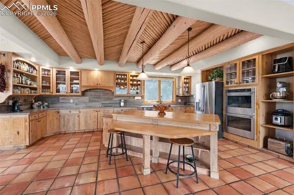 a kitchen with stainless steel appliances granite countertop a stove a sink dishwasher and cabinets with wooden floor