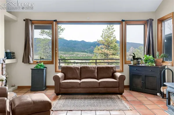 a living room with furniture and a floor to ceiling window
