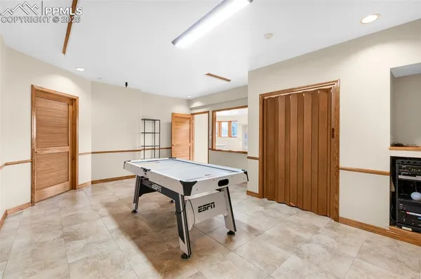 a room with furniture pool table and windows