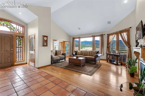 a living room with furniture and floor to ceiling windows