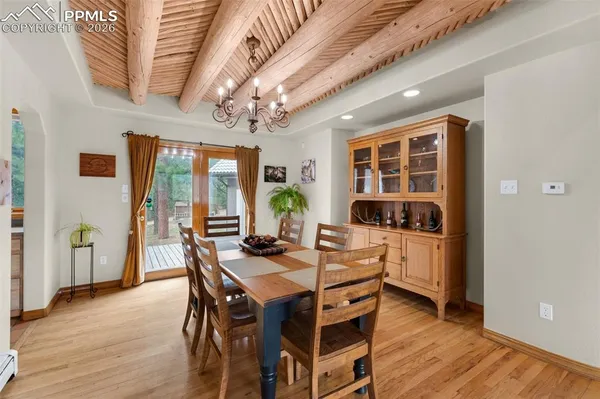 a view of a dining room with furniture window and wooden floor