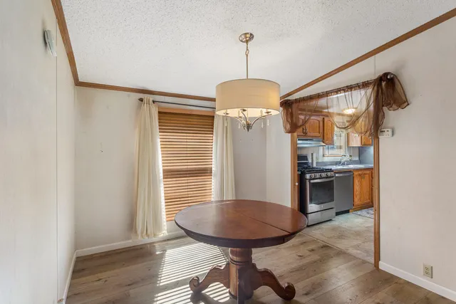 a kitchen with stainless steel appliances granite countertop a refrigerator and a stove