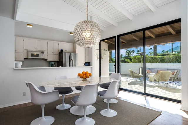 a view of a dining room with furniture wooden floor and chandelier